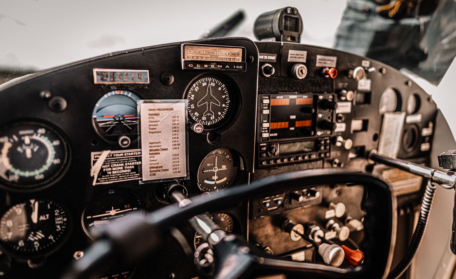 The instrument panel and control yokes of a single-engine light aircraft, seen from the left seat.